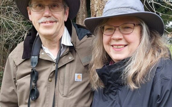 Steve and Martha Ellis stand near a Whidbey forest. (Photo by Beth Stephens)