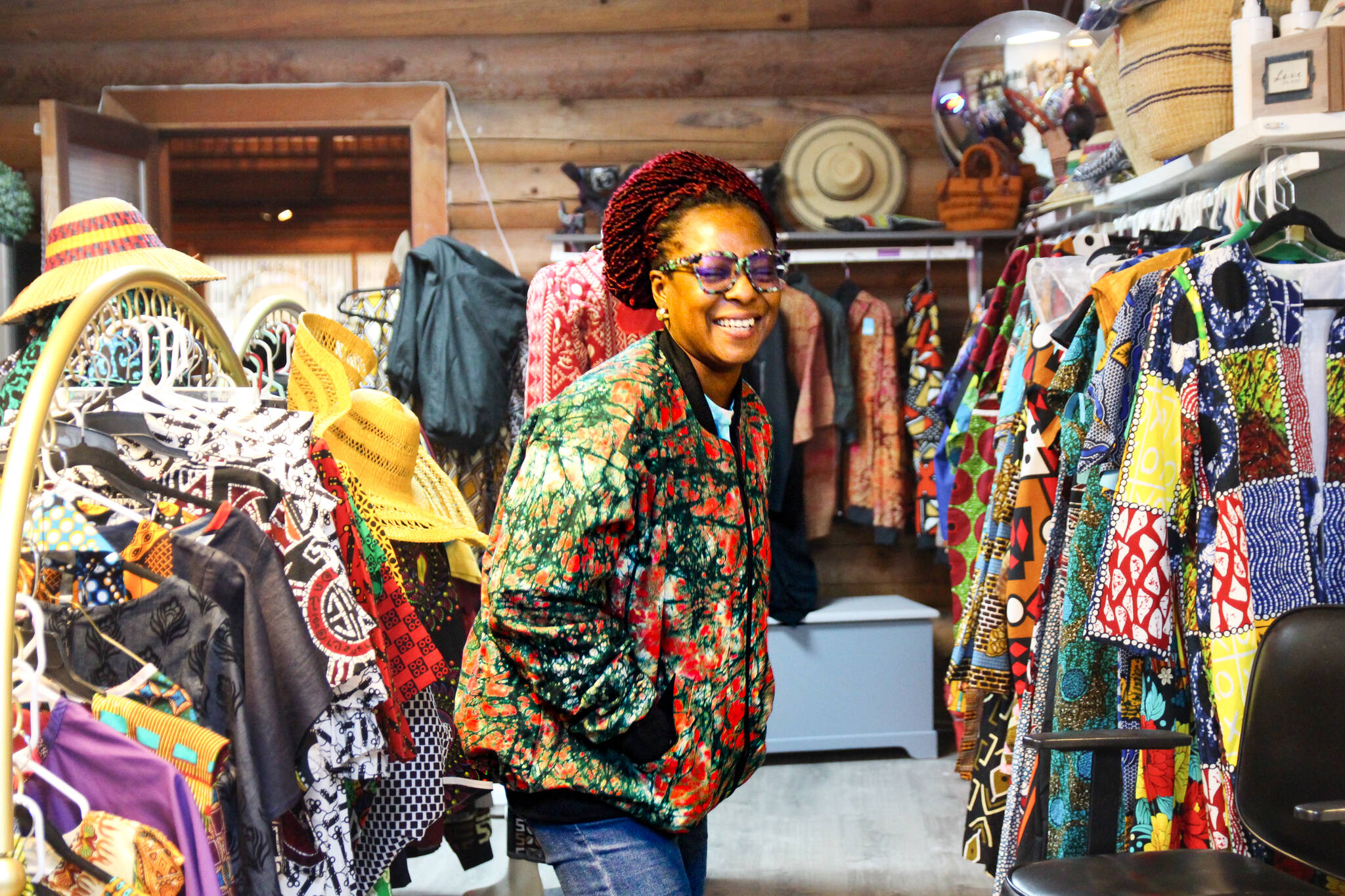 (Photo by Luisa Loi)
Juliet Dei tries on a jacket at the Whidbey African Store, a shop that was created to support female-owned businesses and organizations that educate and empower women in Africa. Her end goal is to eventually open a skills training center in Ghana.