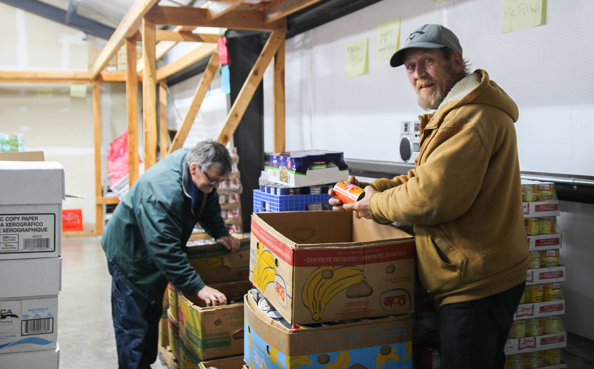 (Photo by Luisa Loi)
At right, Terry Fogle, a driver for the North Whidbey Help House, looks through boxes of holiday foods with Deputy Director Shawn Durbin.