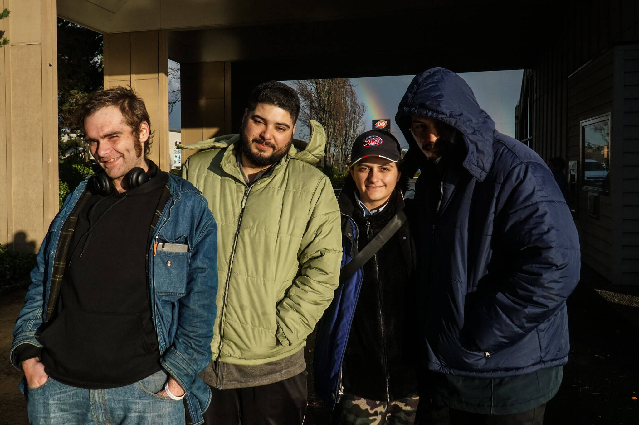 (Photo by Sam Fletcher)
Nick Coloso (at left), Phoenix Welch (second from right) and other patrons of the SPIN Cafe await meals on Friday.