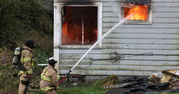 Firefighters from Oak Harbor, North Whidbey, South Whidbey and Naval Air Station Whidbey Island conduct live burn training in Oak Harbor last week. (Photo by John Fisken)