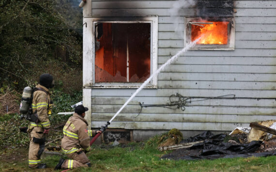 Firefighters from Oak Harbor, North Whidbey, South Whidbey and Naval Air Station Whidbey Island conduct live burn training in Oak Harbor last week. (Photo by John Fisken)