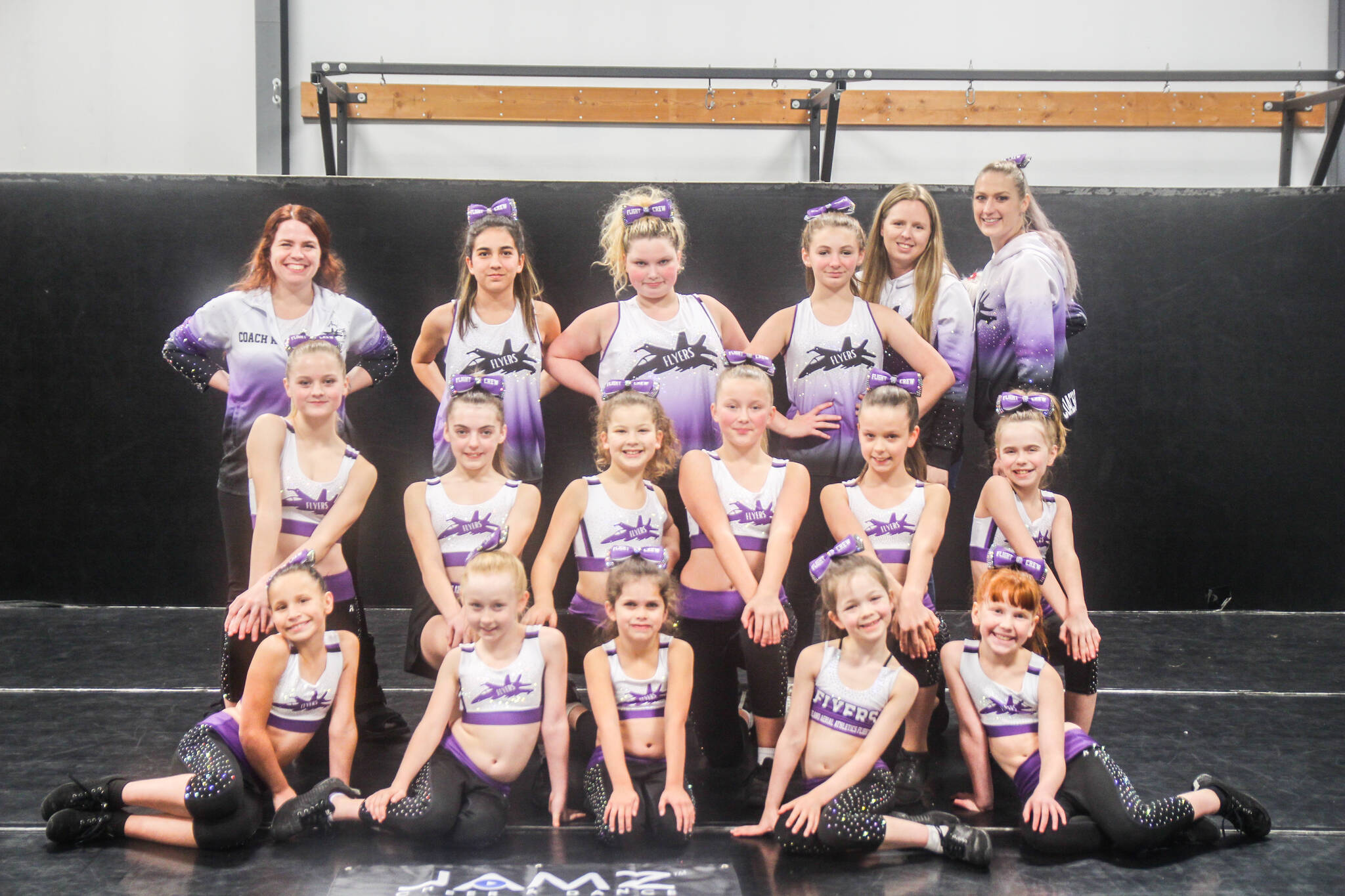 (Photo by Luisa Loi)
The Flyers proudly pose after a successful first competition in Anaheim, California. At left in the back, Kerstin Cornell, Jade Garcia, Maci Walker, Mads Hettenbach, Amy Fallick and Tina Provoncha. In the middle row, Ambria Provoncha, Aubree Blanchard, Mikeal Wood, Amalie Provoncha, Adalyn Watson and Abbigail Bliss. On the front, Annabelle Wold, Sophia Berisford, Willow Valdez, Aria Watson and Samantha Cornell.