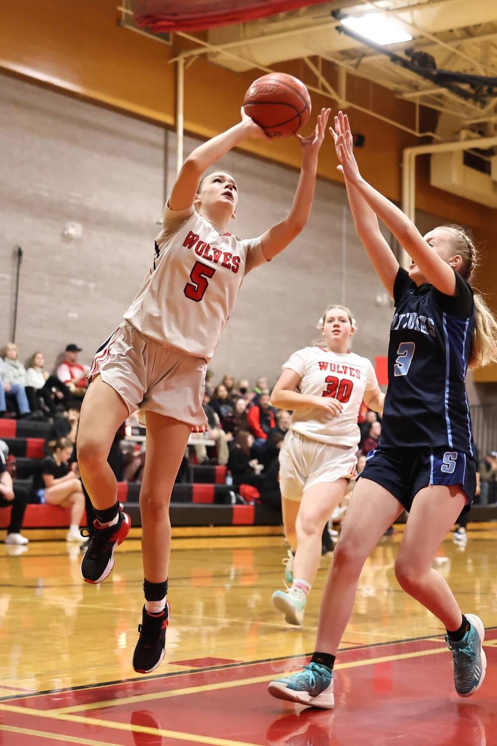 (Photo by John Fisken)
Lexis Drake banks in a shot while Chelsi Stevens comes flying in to help.