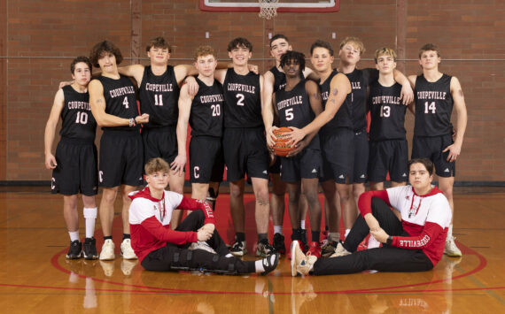 Photo by John Fisken
The boys varsity basketball team poses.