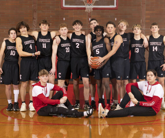 Photo by John Fisken
The boys varsity basketball team poses.