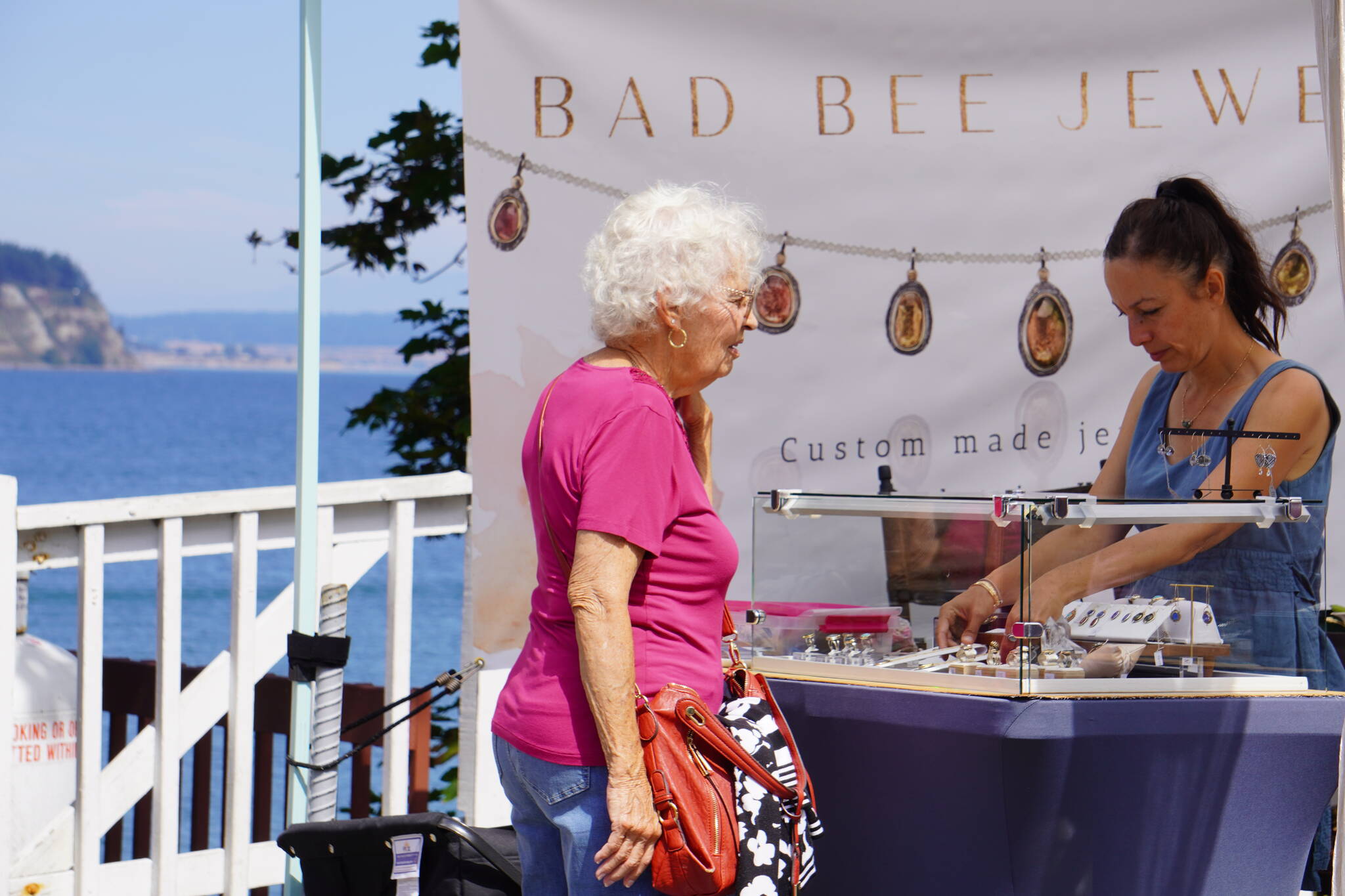 (Photo by the Coupeville Festival Association)
A woman checks out a booth at the Arts and Crafts Festival in Coupeville.