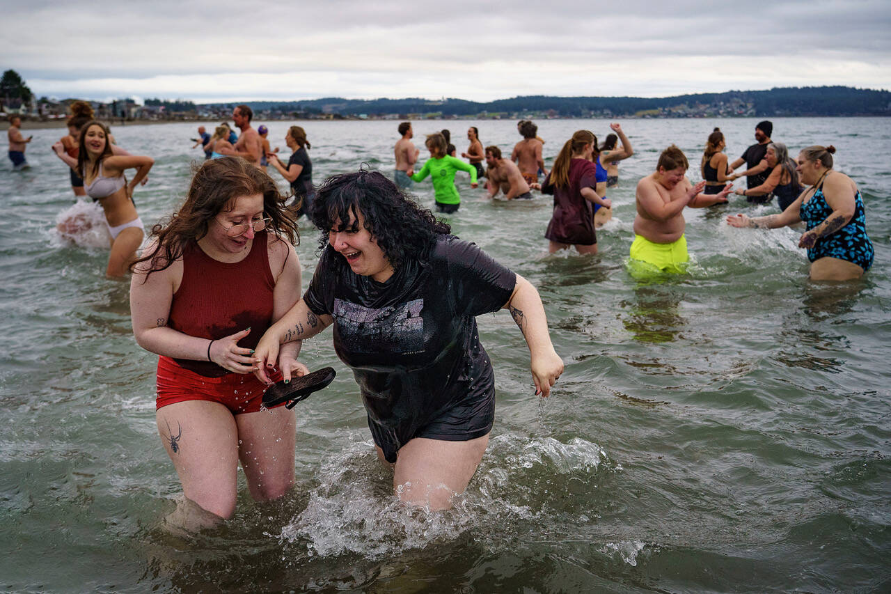 Photo by David Welton
Participants in the Polar Bear Plunge search the cold waters for sandals lost during the excitement.
Photo by David Welton
Participants in the Polar Bear Plunge search the cold waters for sandals lost during the excitement.