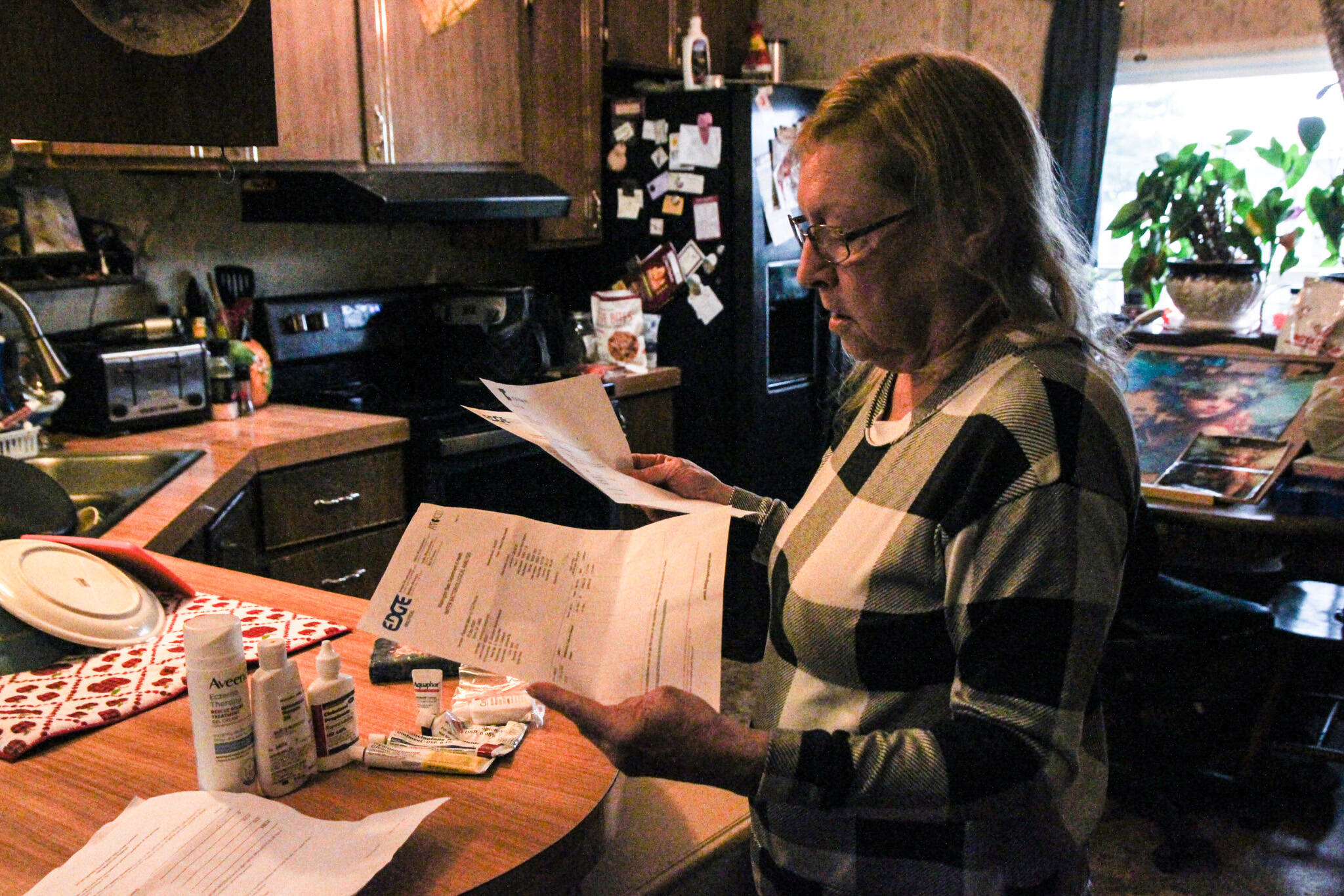 Denis Muller, a resident of Parkwood Manor Mobile Home Park, revies water testing results from Edge Analytical Laboratories. (Photo by Sam Fletcher)