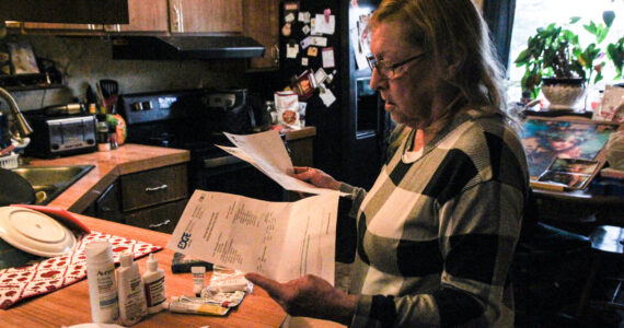 Denis Muller, a resident of Parkwood Manor Mobile Home Park, revies water testing results from Edge Analytical Laboratories. (Photo by Sam Fletcher)