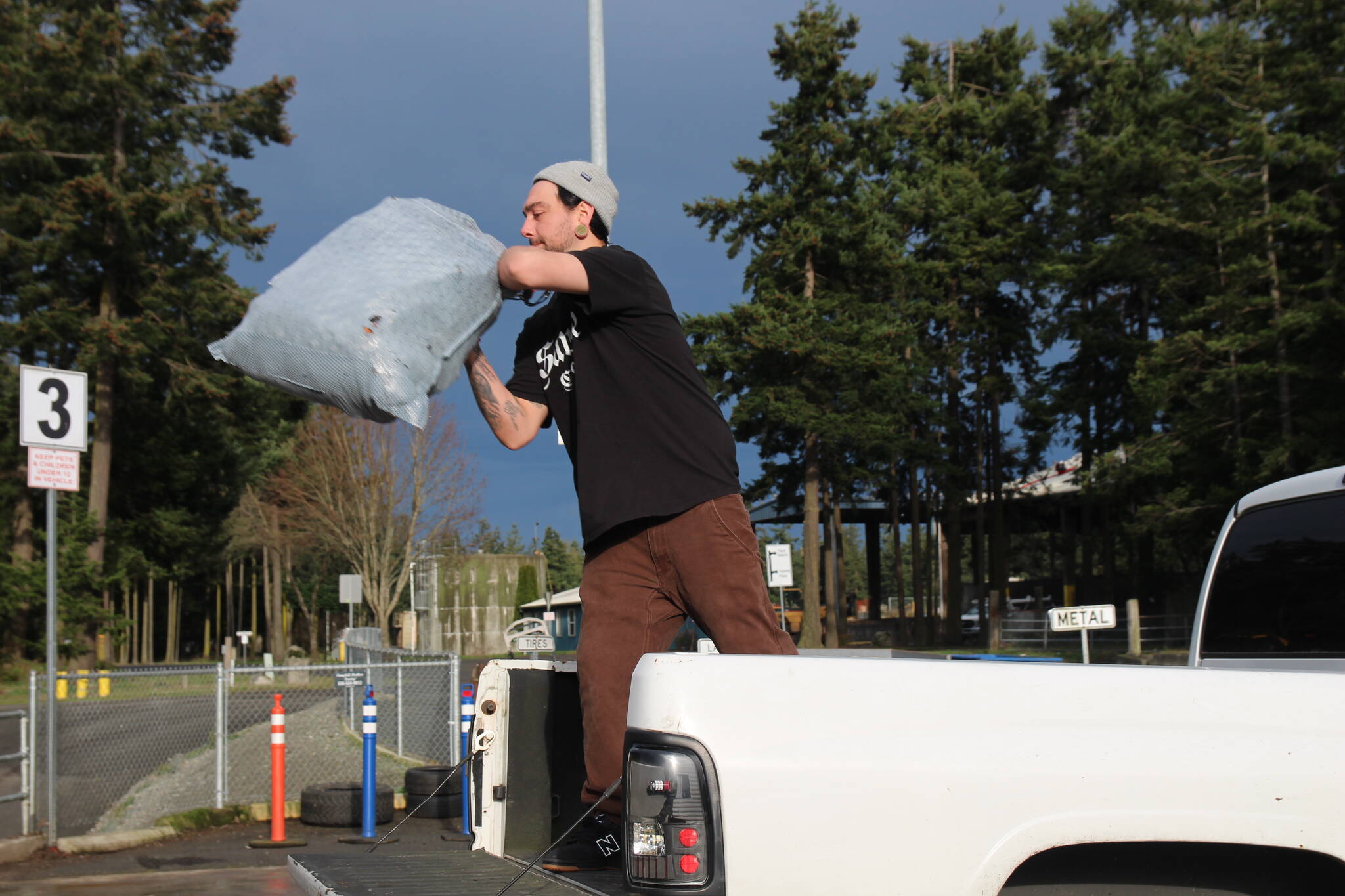 Photo by Ian Tiessen
Warren Blazich throws a bag of trash into the dump at the Island County Transfer Station.